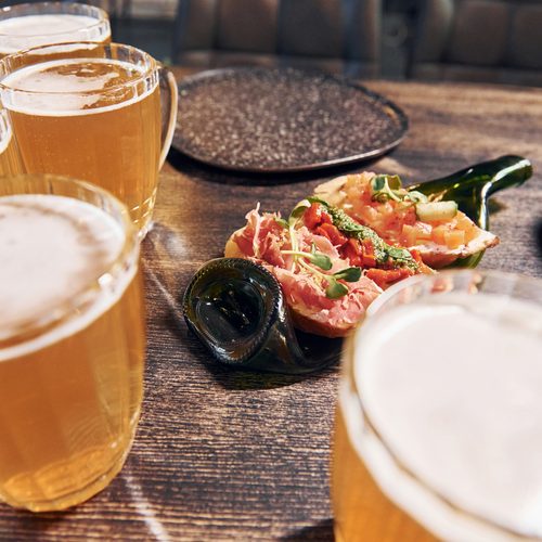 Close up view of food and beer on the table.